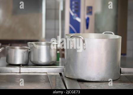 Large metal pans in an industrial kitchen. Stock Photo
