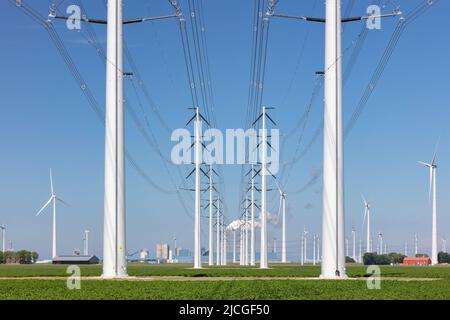 Electricity transmission towers in front of a Dutch power station in Eemshaven, The Netherlands Stock Photo