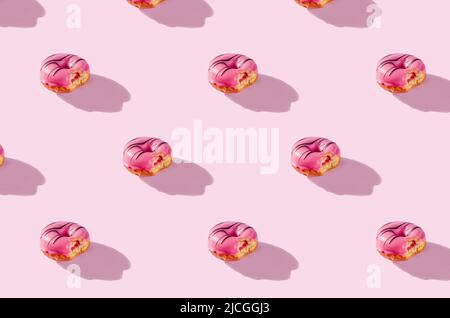 pattern made of Freshly baked donuts for breakfast on a pink background . Sweet background. Bakery, baking concept. Stock Photo