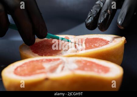 Food testing in the laboratory. The lab technician prepares a sample for microscopic examination Stock Photo