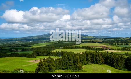 Beautiful green meadow on a cloudy blue sky in São Miguel, Azores Islands, Portugal. Nature amazing Green Landscape of Azores Stock Photo