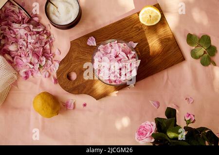 Homemade natural tea rose jam preparing with sugar, lemon and tea rose petals. Healthy recipe. Rustic ingredients. Lifestyle photography. Stock Photo