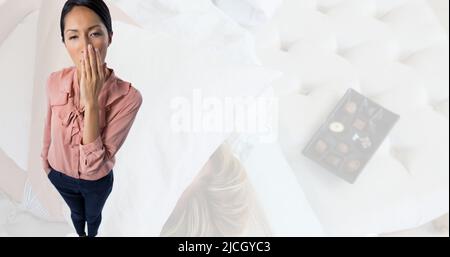 Digital composite image of young asian woman yawning, copy space Stock Photo