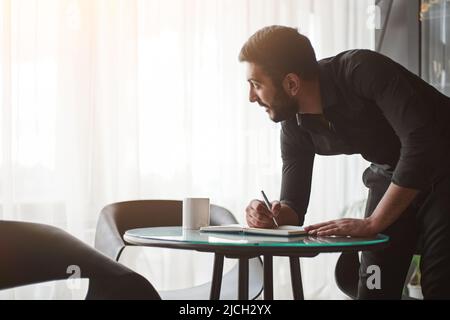 young business man taking notes in his notebook. Stock Photo