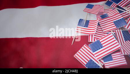 Close up view of multiple miniature american flags with copy space on american flag background Stock Photo