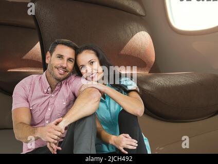 Composite image of caucasian couple smiling against airplane window in background Stock Photo
