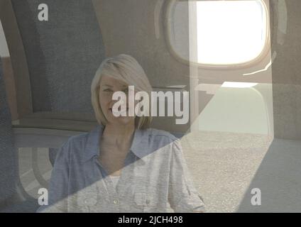 Composite image of caucasian senior woman smiling against airplane window in background Stock Photo
