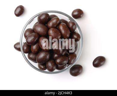 Top view of chocolate covered peanuts in glass bowl isolated on white Stock Photo