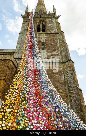 The north tower of All Saints church in Middleton Cheney decorated with crochet flower and animals for the Queens Platinum Jubilee. Stock Photo