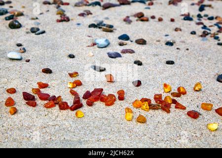 Amber in the sand. Amber on the seashore. Sun stone Stock Photo