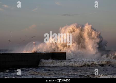 Big wave splash at dawn. Douro river mouth, north of Portugal. Stock Photo