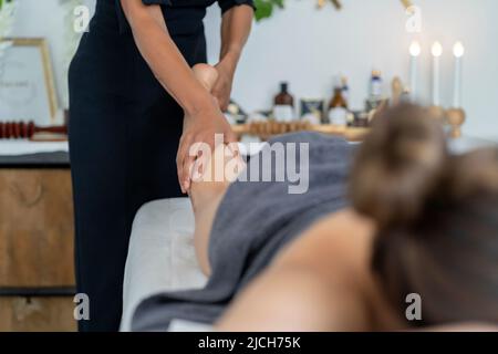 client receiving a relaxing leg massage from a masseuse Stock Photo