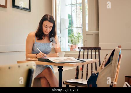 Young illustrator works from a coffee shop Stock Photo