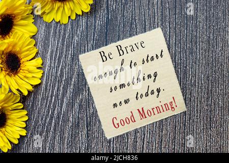 Motivational quote on torn brown paper - Be brave enough to start something new today, good morning. Stock Photo