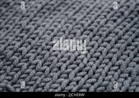 Knitted grey background, gray sweater pattern. Stock Photo
