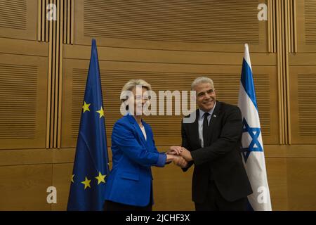 Jerusalem, Israel. 13th June, 2022. European Commission President Ursula von der Leyen (L) poses for a photograph with Israeli Foreign Minister Yair Lapid before their meeting in the Knesset, Israel's Parliament, in Jerusalem, Monday, June 13, 2022. Pool photo by Maya Alleruzzo/UPI Credit: UPI/Alamy Live News Stock Photo