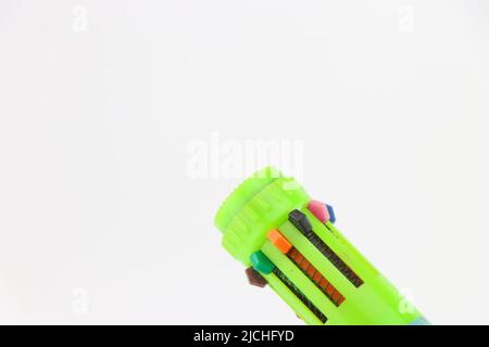 Multicolored pen with an option to choose different color ink held in the hand Stock Photo