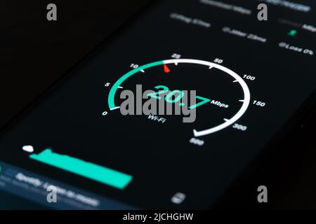 Close-up of the result of checking the Internet speed on a mobile phone on a black background Stock Photo