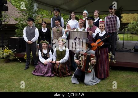 Riga Dance Club dancers in national costumes posing for photos before dance performance at The Ethnographic Open-Air Museum of Latvia, Riga, Latvia Stock Photo