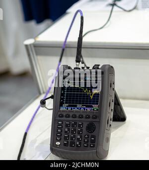 Handheld Signal Analyzer for Satellite Communication Testing Stock Photo