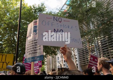 London, UK. 13th June, 2022. Protesters demonstrate outside the Home Office against the plan to relocate individuals identified as illegal immigrants or asylum seekers to Rwanda for processing, resettlement and asylum with the first deportation flight scheduled for 14th June. Credit: Wiktor Szymanowicz/Alamy Live News Stock Photo