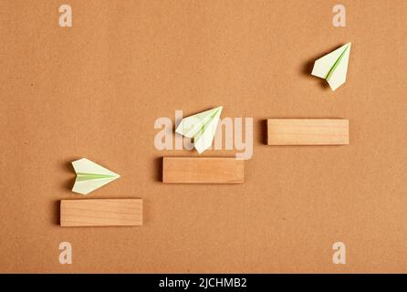 Progress, development concept. Origami planes flying up stairs. Professional, personal growth, success. High quality photo Stock Photo