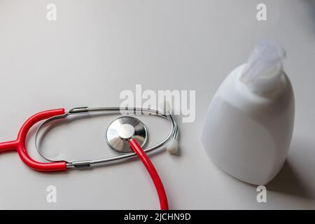 Doctors stethoscope and hand soap dispenser bottle with copy space on white table show hygienic prevention and disinfection and virus prevention Stock Photo
