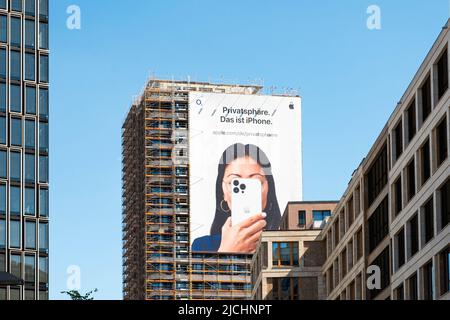 Berlin, Germany -June, 2022: Apple Iphone advertisement on billboard on building facade Stock Photo