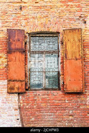 Old building brick wall with an window with hinged shutters. Windows of an old building Stock Photo
