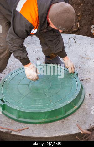 Utility worker construction pit for a septic tank the sewerage manhole ...