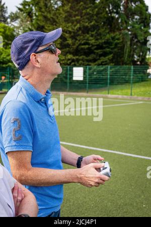 Crew / pilot operating a DJI Mini 3 Pro drone (UAV) using remote control Stock Photo