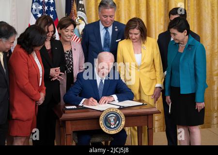 United States President Joe Biden signs into law R. 3525, the âCommission To Study the Potential Creation of a National Museum of Asian Pacific American History and Culture Actâ at the White House in Washington, DC, June 13, 2022. Also pictured: United States Representative Grace Meng (Democrat of New York), US Vice President Kamala Harris, second from left, US Representative Young Kim (Republican of California), US Representative Mark Takano (Democrat of California), and Speaker of the United States House of Representatives Nancy Pelosi (Democrat of California). Credit: Chris Kleponis/C Stock Photo