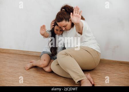 Mother hugging frightened little girl in dark room, victims of mafia,  kidnapping - Observatório do 3° Setor