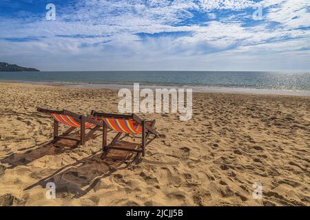 Beach summer travel vacation concept with chair white sand beach blue sky and sea water ocean Stock Photo