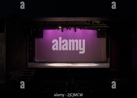 Empty Old-fashioned Stage Lit in Pink on Cyclorama Stock Photo