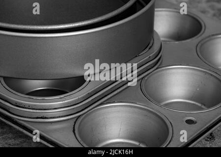 Baking trays and cake tins on a black stone background. Cooking utensils concept Stock Photo