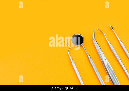 Dentist tools. Teethcare, dental health concept. orange background top view copy space Stock Photo