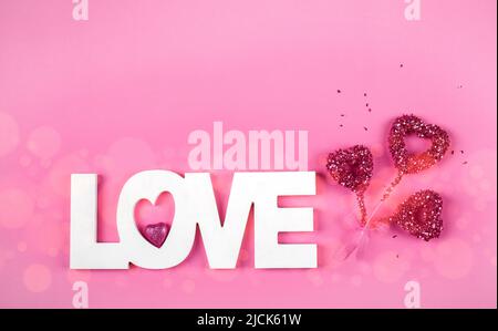 Greeting card for Valentines day with word Love and pink hearts, copy space. Stock Photo
