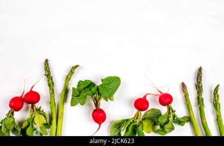 Fresh spring vegetables on white background, copy space. Stock Photo