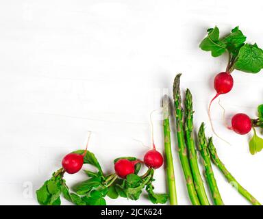 Fresh spring vegetables on white background, copy space. Stock Photo