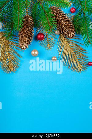 Christmas background with fir tree, pine cones and golden decoration, copy space. Stock Photo
