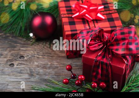 Christmas background with gift boxes and fir branches on wooden table, copy space. Stock Photo