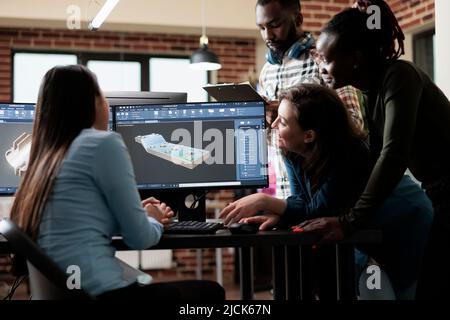 Creative agency employees brainstorming together to find solutions in order to optimise 3D scene. Digital artists working together using advanced specialized software to improve mesh geometry. Stock Photo