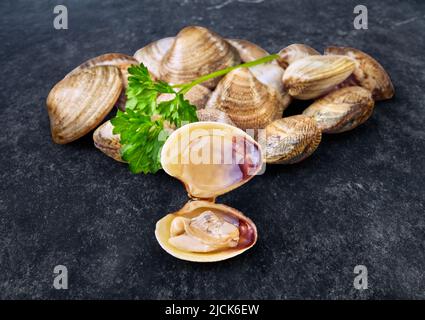 open en closed clams with shellfish isolated on black background. Stock Photo
