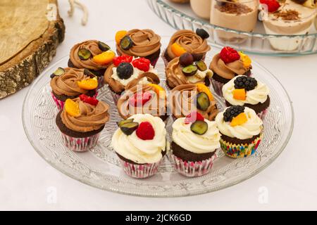 Tasty cupcakes on a glass plate beautifully arranged Stock Photo