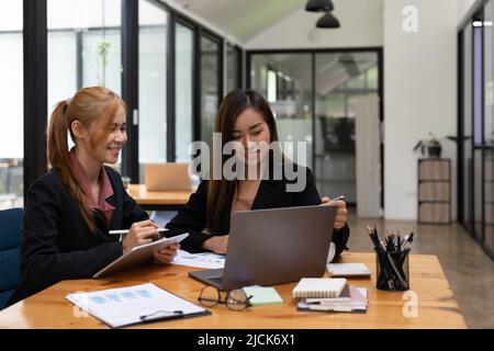 Asian Business People Planning Strategy Analysis from financial document report, Office Concept Stock Photo