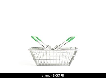 Shopping cart in a supermarket on an empty white background isolate. Shopping, groceries, goods concept. High quality photo Stock Photo