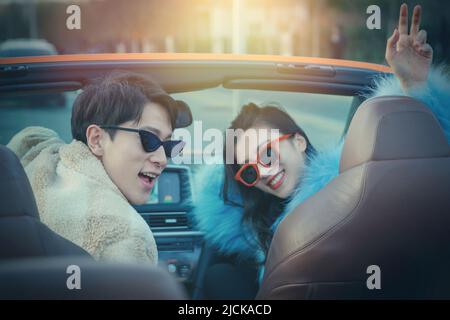 Fashionable young couples driving car for a ride Stock Photo - Alamy