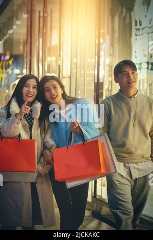 Happy fashionable young people go shopping Stock Photo