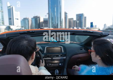 Fashionable young couples driving car for a ride Stock Photo - Alamy